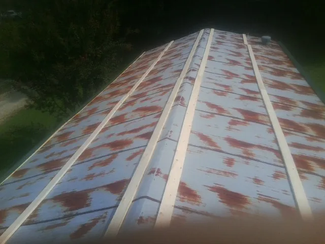 Rusted metal roof panels with new wood purlins before replacement — Storm Damage Roof Repair in Hodges by Roofing Brothers